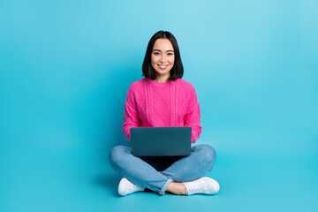 Full length photo of adorable pretty lady wear pink pullover typing modern device isolated blue color background