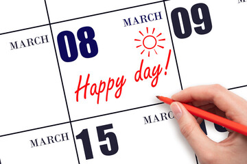 Hand writing the text HAPPY DAY and drawing the sun on the calendar date March 8