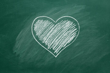 One heart are hand drawn with chalk on a greenboard. Valentines day. I Love You. Health care concept.
