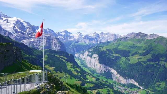 Swiss flag, landscape of Monch, Eiger, and Jungfrau mountains. Switzerland most popular destinations for tourists.