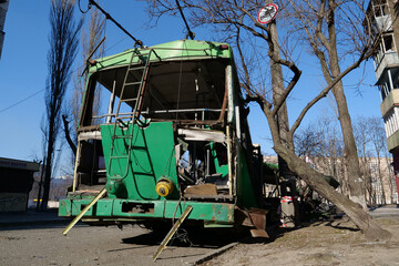 Fototapeta na wymiar Russian missile destroyed green trolleybus and houses in Kyiv, Ukraine