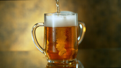 Freshly brewed beer in a pint on orange gradient background, close-up