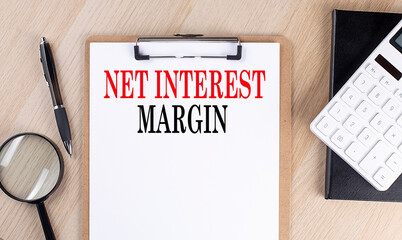 NET INTEREST MARGIN text on a clipboard on wooden background