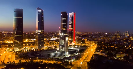 Fotobehang Panoramic view from drone of illuminated Cuatro Torres Business Area at night, Madrid, Spain © JackF