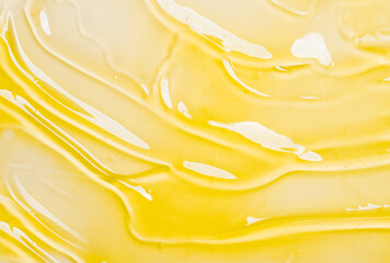 Gel serum yellow transparent texture cosmetics background, skincare hyaluronic acid vitamin C product gel smudge.	