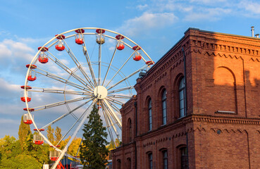 Brick building and ferris wheel in Manufaktura in Lodz