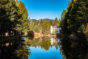 A traditional house reflecting off the water in South Lake Tahoe, CA.