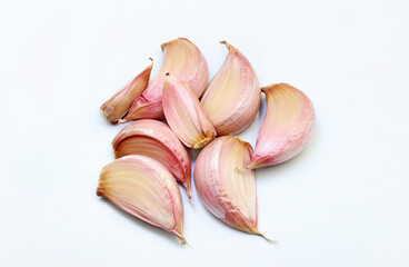 A group of garlic cloves on white background
