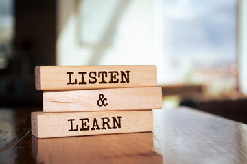 Wooden blocks with words 'Listen and Learn'.