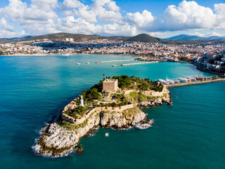 View of Guvercinada or Pigeon Island in the Aegean Sea with the Kusadasi Pirate castle in summer...