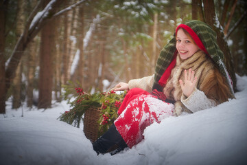 Nice cute teenager girl in old peasant clothes with hot fur coat and shawl in cold winter forest...