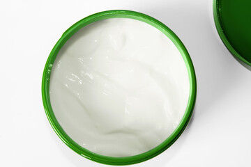 Jar of green cream. Cream on a light background.