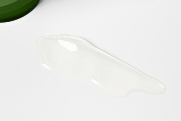 Aloe gel on a light background and a bottle of green.