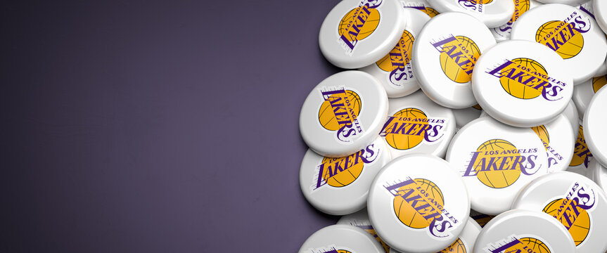 Logos of the American NBA Basketball Team Los Angeles Lakers on a heap on a table.