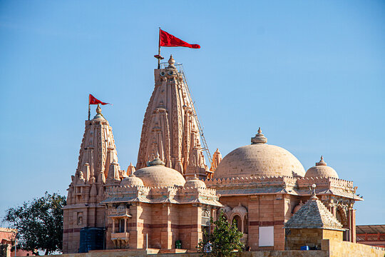 Koteshwar Mahadev Temple with Red pendant flying on top situated in Koteshwar Gujarat at the Kori Creek during low tide