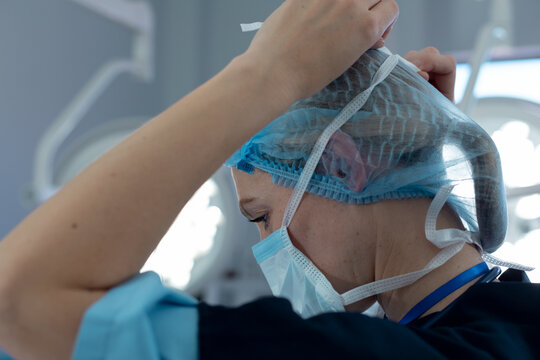 Caucasian Female Doctor Wearing Hair Net And Face Mask Working At Hospital