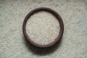 
ceramic cup with white rice on white rice with space for text