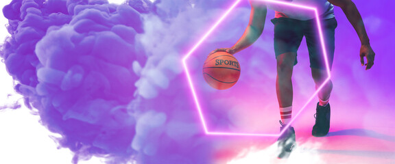 Low section of biracial basketball player dribbling ball by illuminated hexagon on smoky background