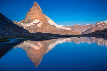 Reflection of the Matterhorn on blue lake at sunrise, Swiss Alps, Zermatt