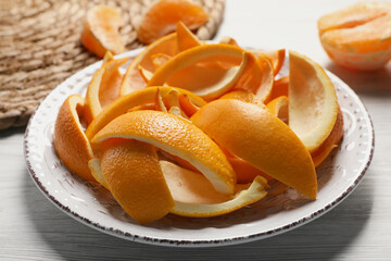 Orange peels preparing for drying on white wooden table, closeup