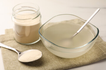 Agar-agar jelly and powder on white table, closeup