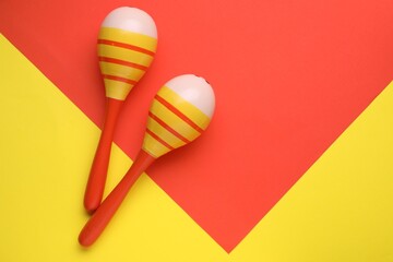 Maracas on colorful background, flat lay with space for text. Musical instrument
