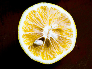 Lemon with a seed on a black background