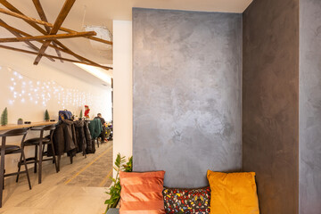 Corner of a cafe bar with bench with cushions