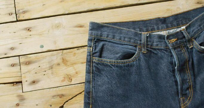 Close up of jeans on wooden background with copy space