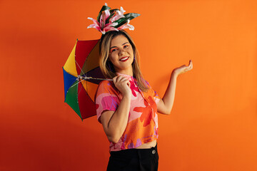 Fototapeta na wymiar Brazilian Carnival. Studio shot of young woman in costume dancing Frevo