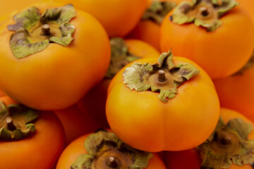 Delicious ripe juicy persimmons as background, closeup