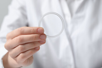 Doctor holding diaphragm vaginal contraceptive ring, closeup
