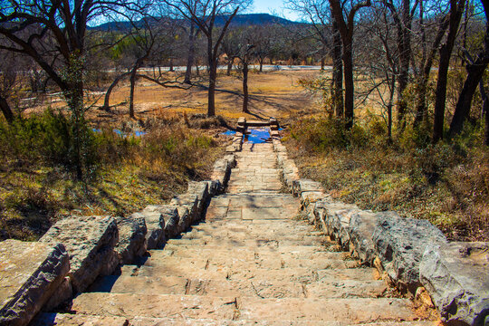 Limestone stairs leading down the footpath to a small creek and picnic area in the Abeliene State Park in the Fall. Many people enjoy Camping and fishing at the lake.