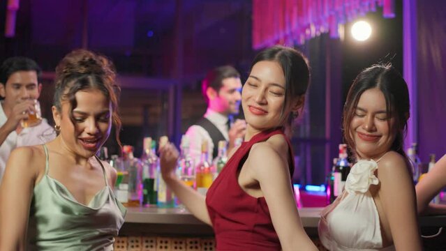Asian beautiful women having fun, dancing with music in bar restaurant.