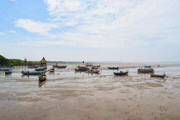 Fishing boat on the beach with blue sky background in Indonesia