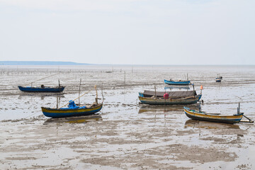Fototapeta na wymiar Fishing boat on the beach with blue sky background in Indonesia