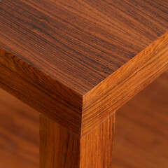 Mid-century modern dining room table. Vintage rosewood furniture. Interior close-up of the corner with wood grain texture.