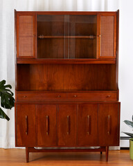Vintage walnut display cabinet. Red Mid-Century Modern hutch. Interior product photograph. 