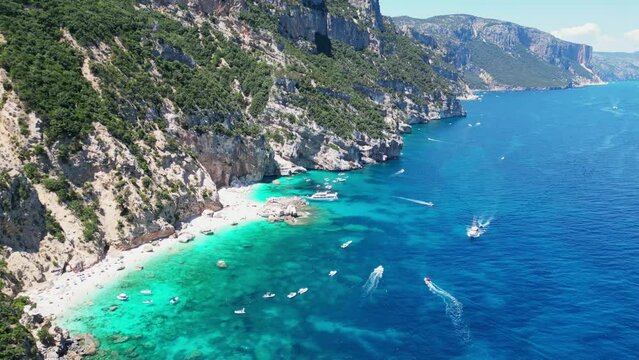 Boat Tour Excursion at Cala Mariolu Beach, Baunei Coast, Sardinia, Italy - Aerial 4k Circling