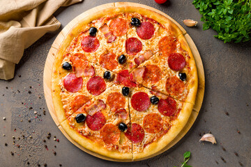 Italian meat pizza on wooden board top view