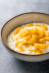 rice porridge with mango and coconut macro close up vertical