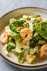 salad with shrimp, avocado and greens macro close up vertical