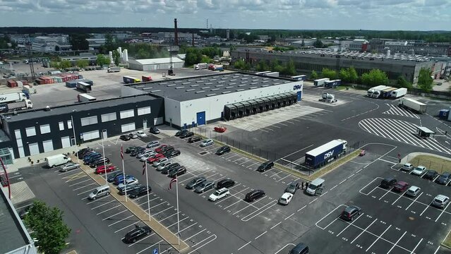 Logistics center and parked trucks in industrial zone of Riga in Latvia. Aerial forward 