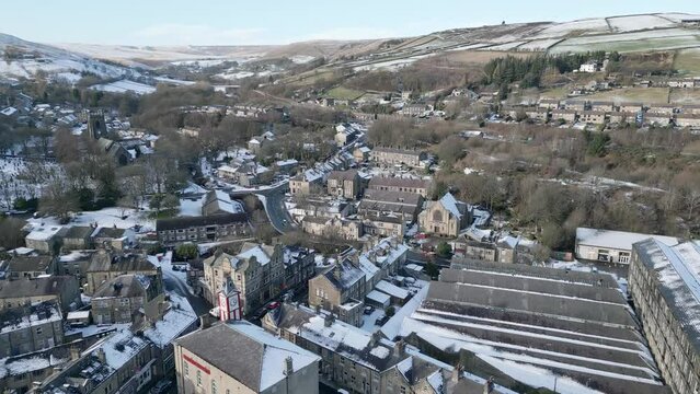 Cold winter Cinematic Cityscape Townscape with snow covered roof tops Panorama 4K Marsden Village West Yorkshire, Endland.