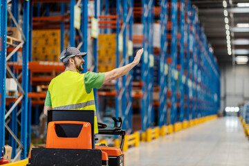 A warehouseman is driving forklift in facility. © Dusan Petkovic