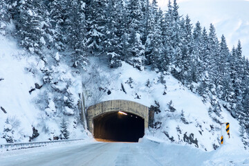Mountain tunnel in winter surrounded by snow