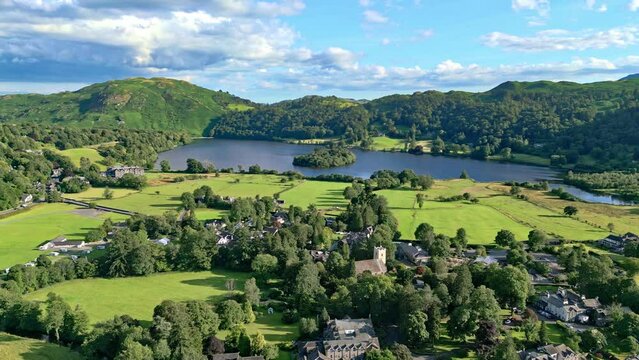 Cinematic aerial drone view of the Lakeland town of Grasmere. Showing the small lakeland town. Lake District National Park, Cumbria.