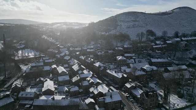 Cold Snowy Winter Cinematic aerial view cityscape townscape with snow covered roof tops Panorama 4K Delph Village West Yorkshire, Endland. UK