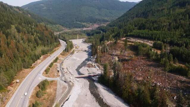 Construction of the TMX oil and gas pipeline in British Columbia Canada. Building an oil pipeline near a river.