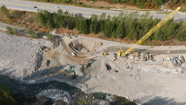 Construction of the TMX oil and gas pipeline in British Columbia Canada. Building an oil pipeline near a river.